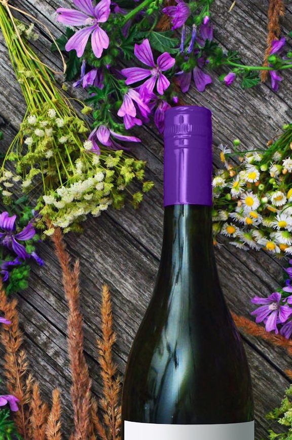 photo of wine bottles near flowers Photo by Adonyi Gábor on Pexels.com